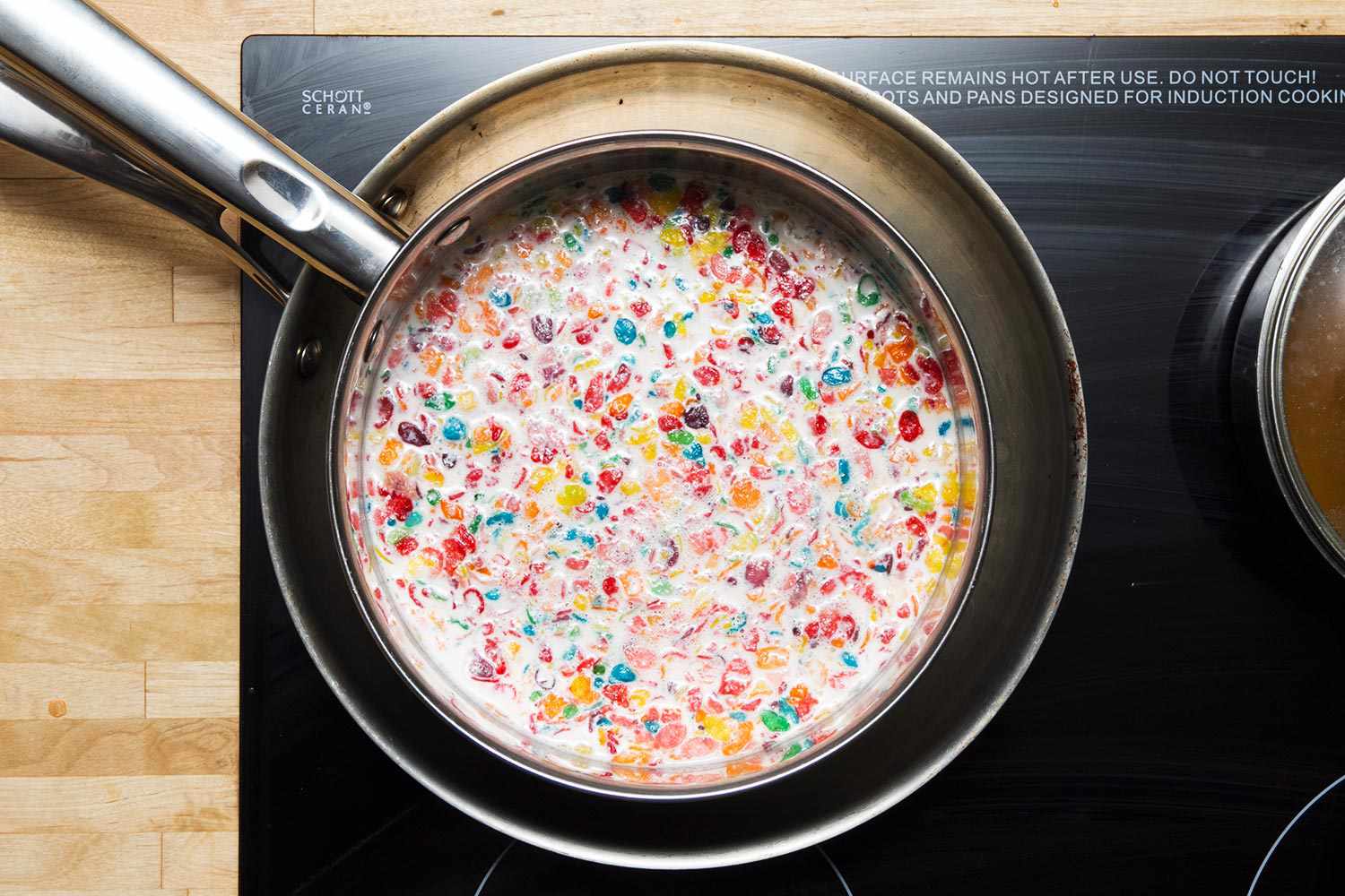 Fruit Pebble cereal steeping in a mixture of cream and milk. 