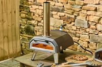 The Ooni Karu 2 Multi-Fuel Pizza Oven outside on a table