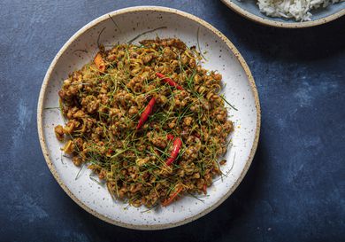 A plate of Khua Kling Gai on a blue table