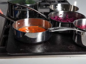 Side view of saucepans on a baking steel.