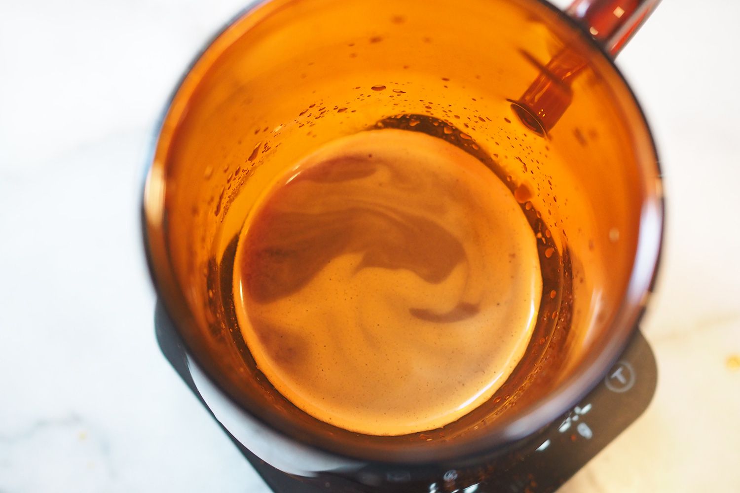 showing the inside of orange glass mug