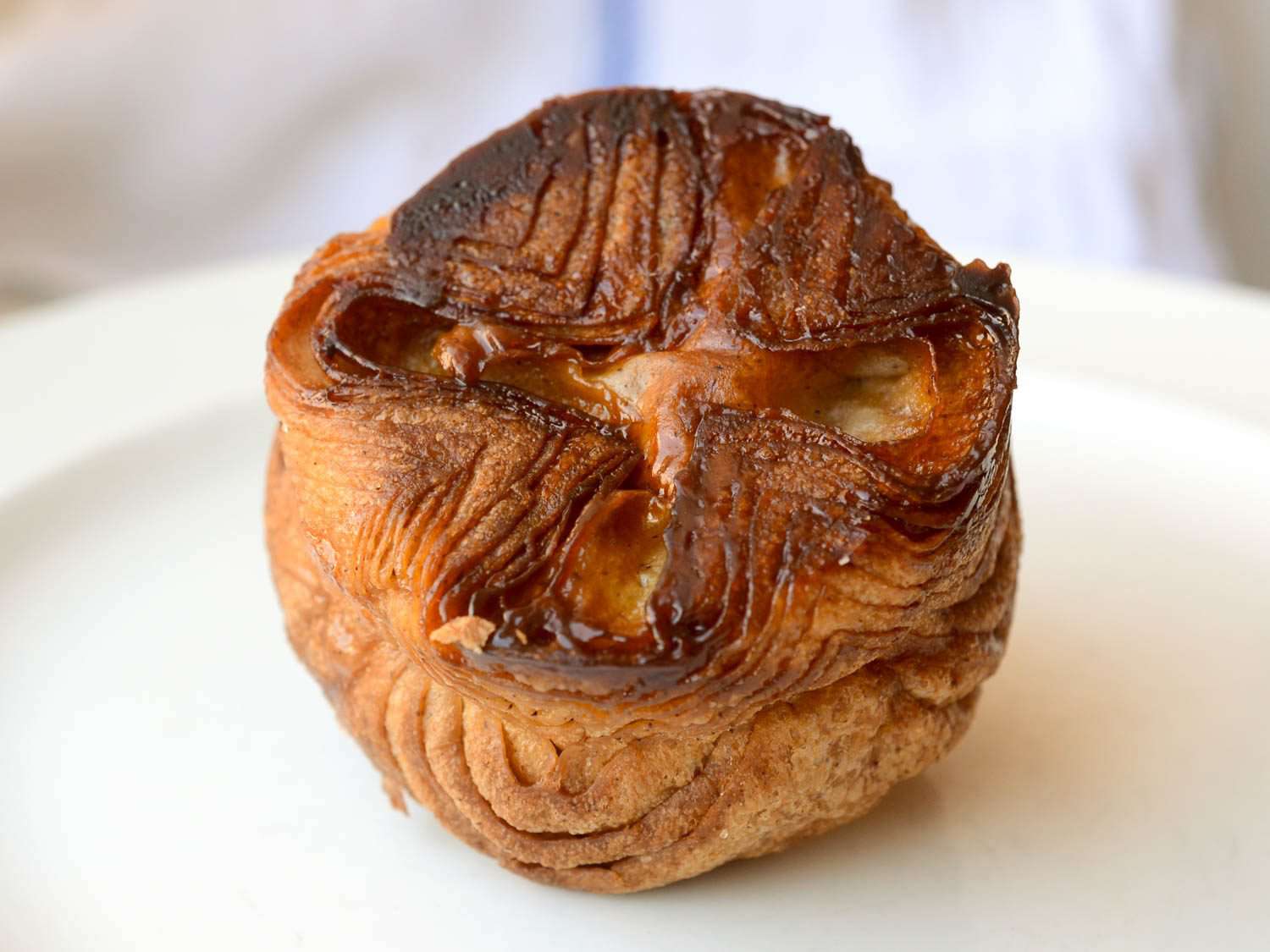 Kouign amann on white serving plate.