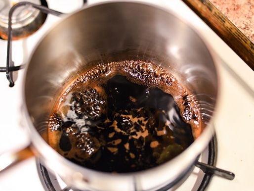 Balsamic vinegar simmering in a saucepan.