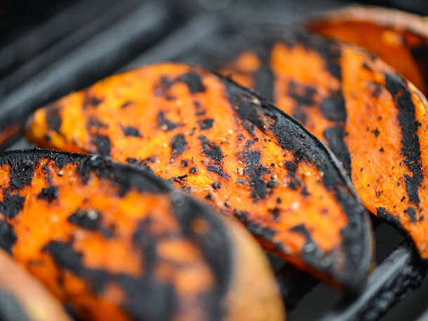 Sweet potato wedges grilling on the grill. 