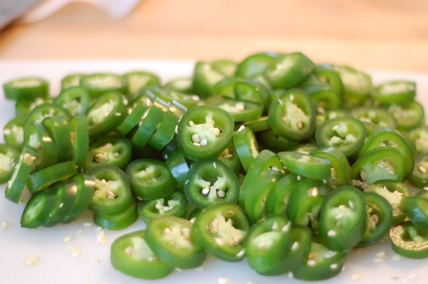 A pile of jalapeño slices, ready to be candied.