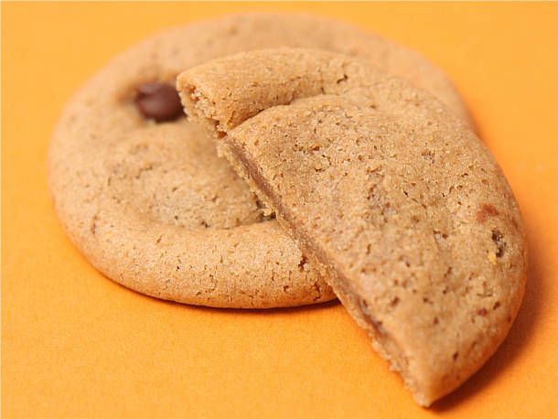 Closeup of mock batch cookies. One has been cut in half to show the soft interior.