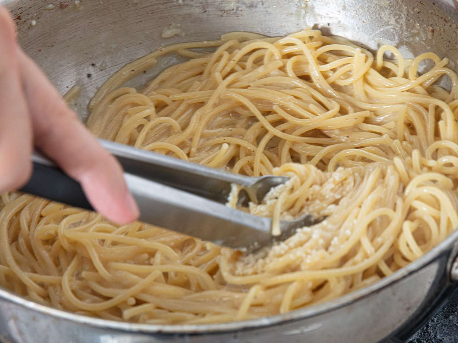 Overhead view of stirring pasta