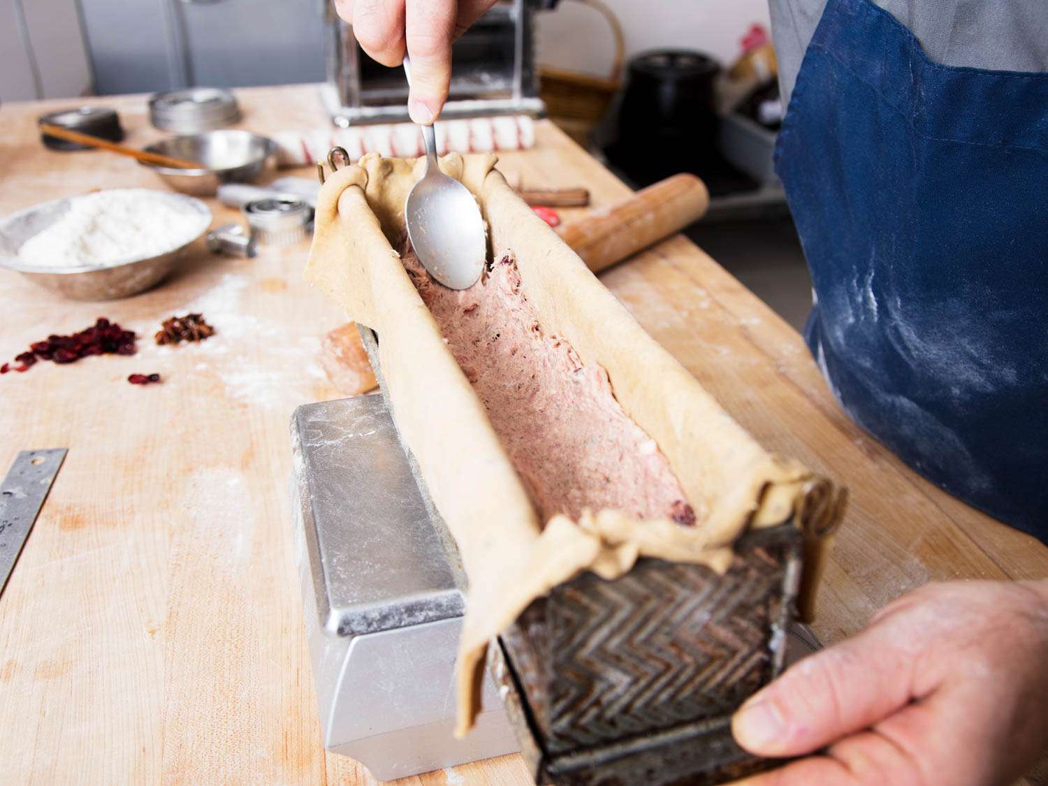Shapiro assembles a pâté en croûte, smoothing the forcemeat in a pastry-lined mold.