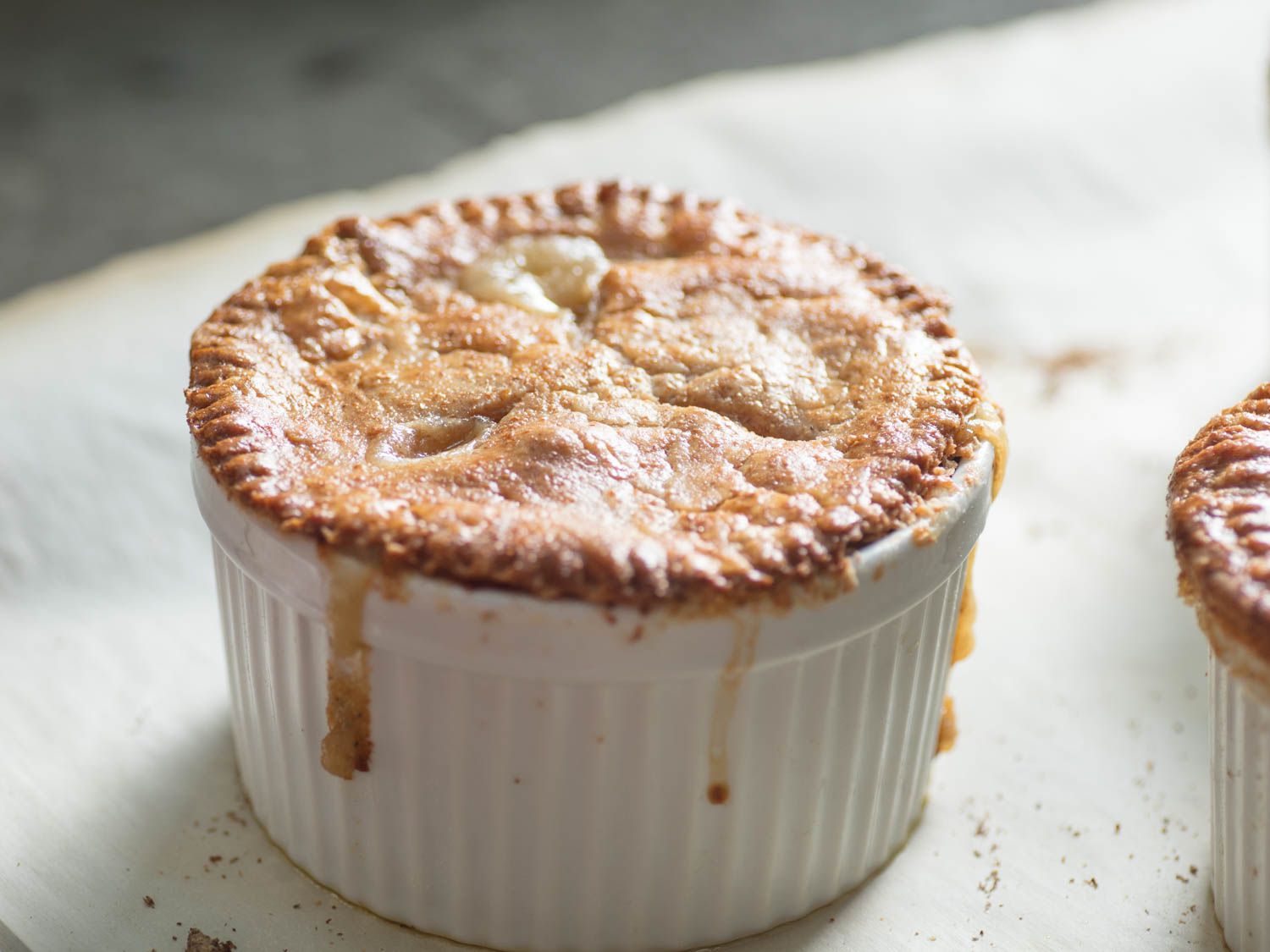 A just-cooked, golden-brown individual chicken pot pie.