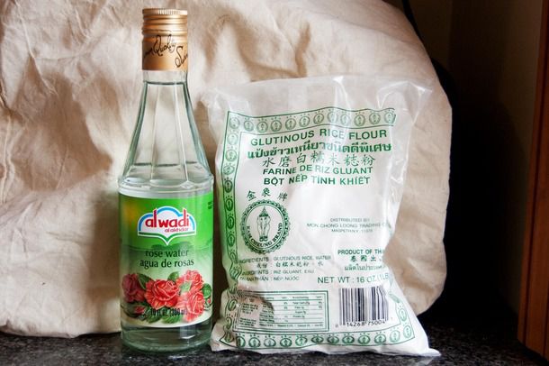 A bottle of rose water and a bag of glutinous rice, ingredients for salep.
