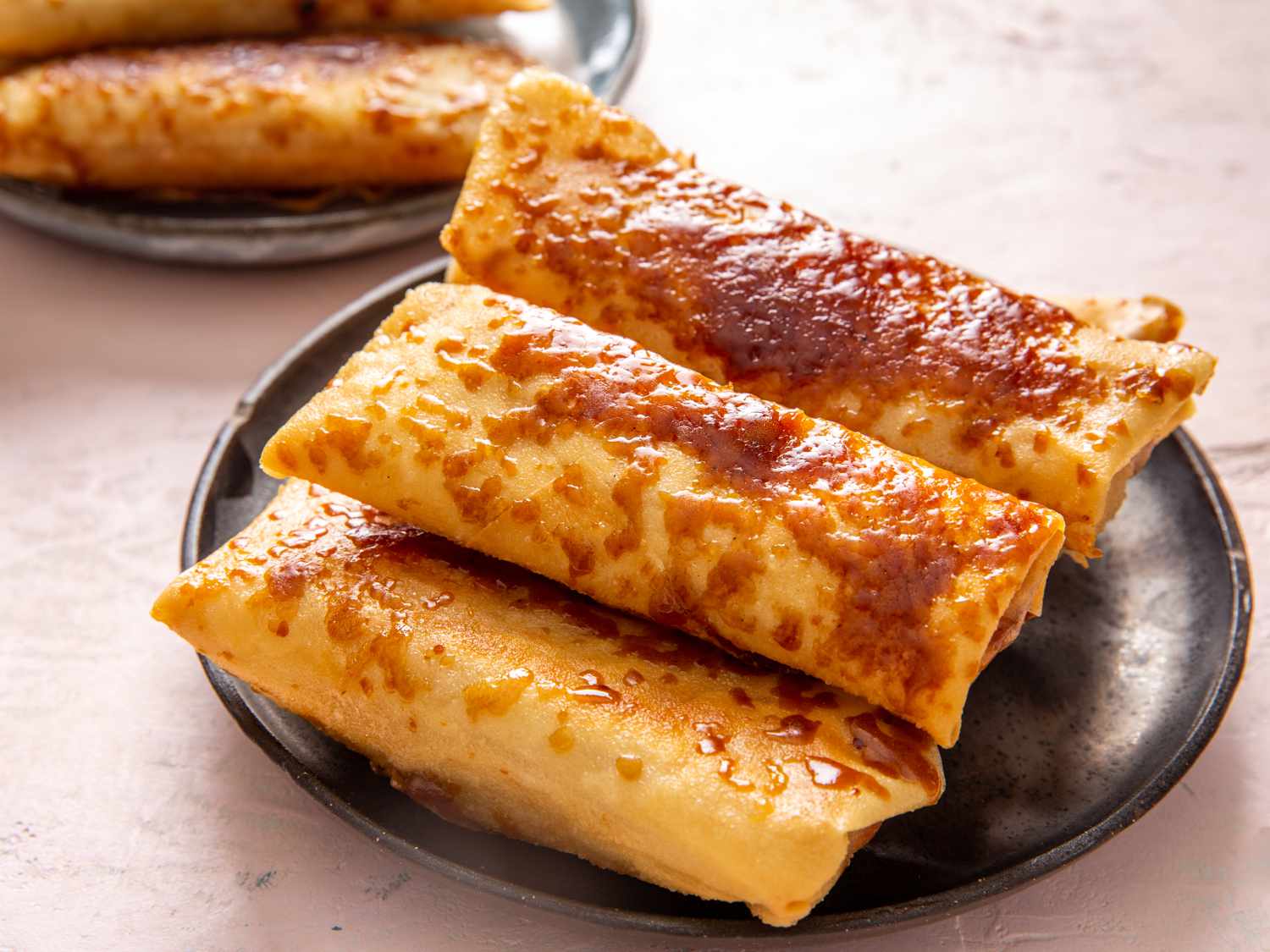 a pile of turon on a small black plate