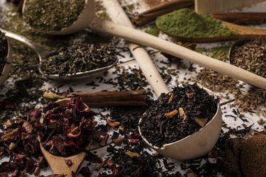 Variety of looseleaf teas and herbs scattered on a surface