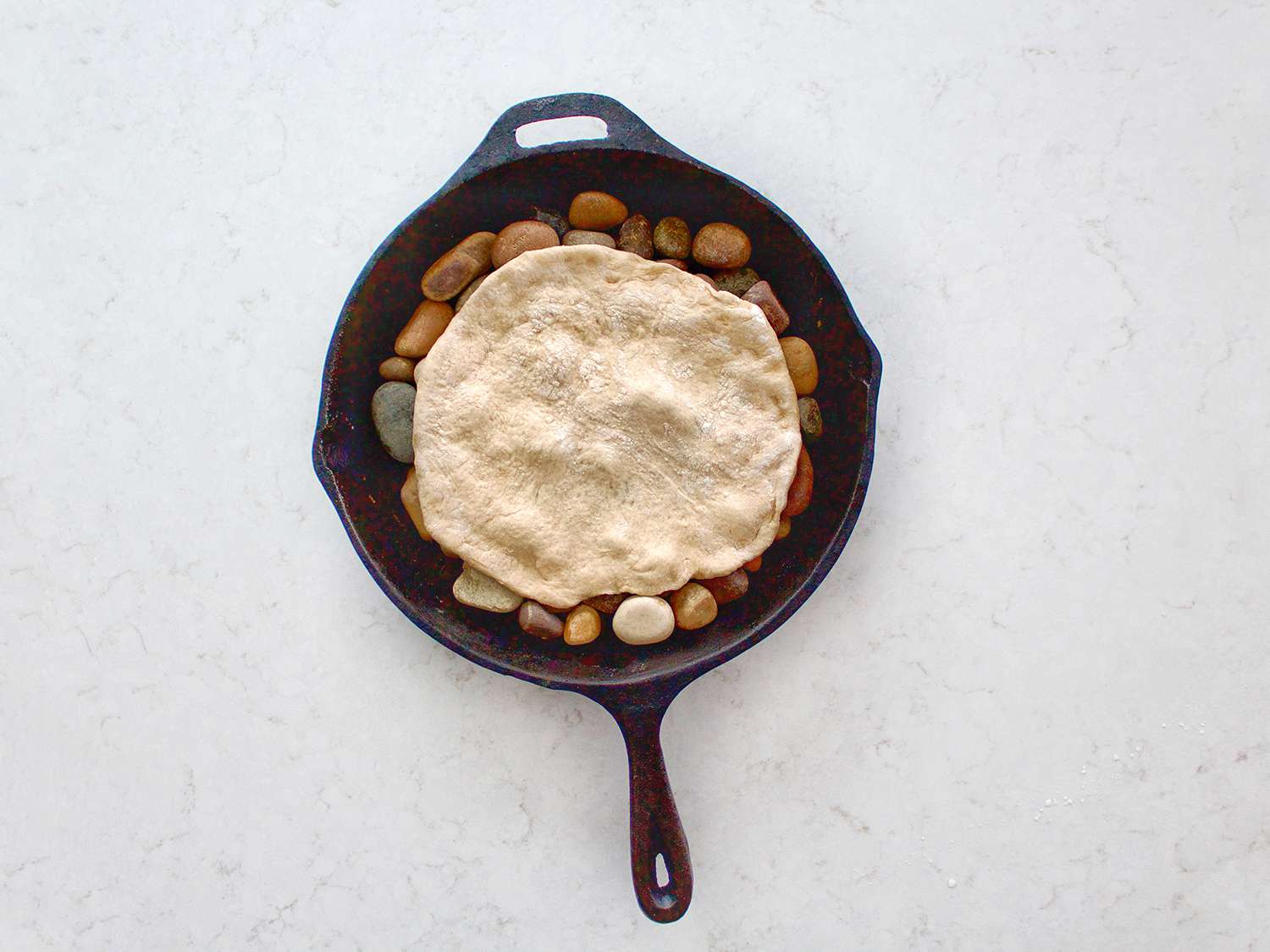 Taboon dough placed on river rocks.