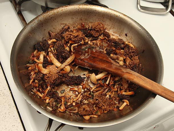 Rehydrated mushrooms are sautéed in a skillet.