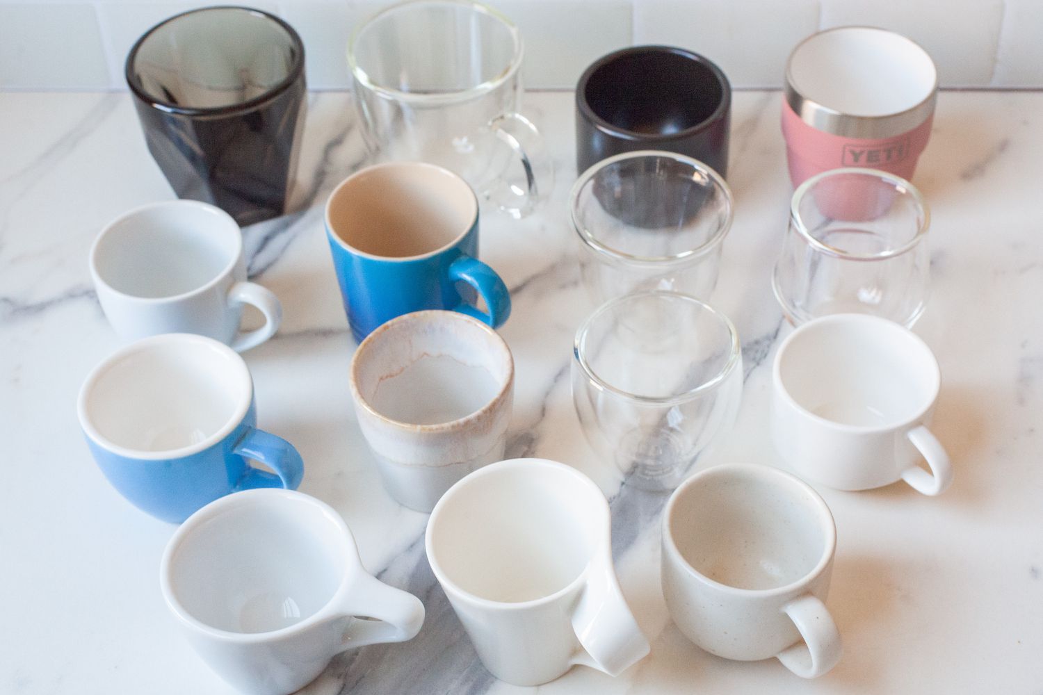 group of espresso mugs on a marble countertop 