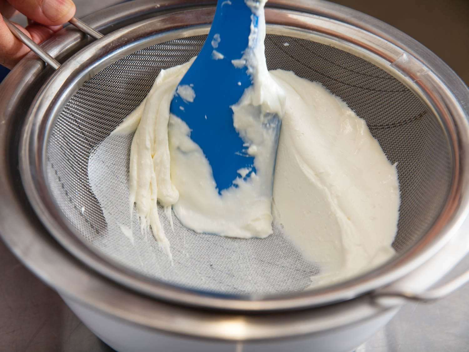 Pressing whipped feta through a fine-mesh strainer for an even silkier texture.