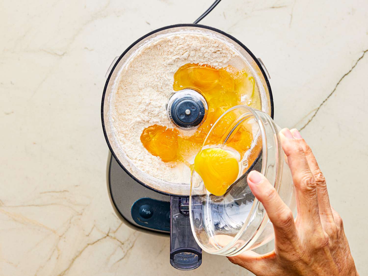 Adding egg yolk to blender