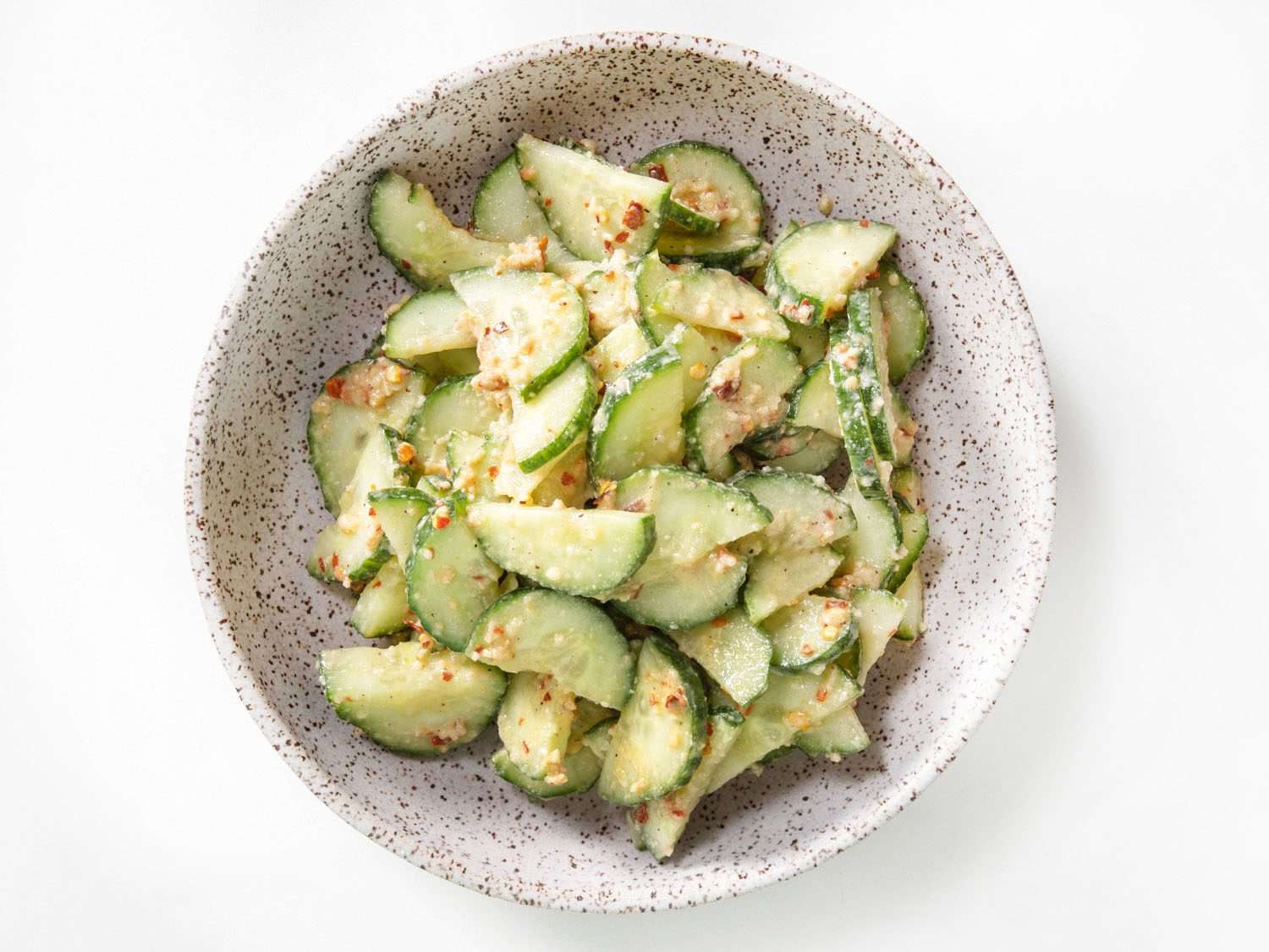 Overhead view of mustard oil-dressed cucumber salad.