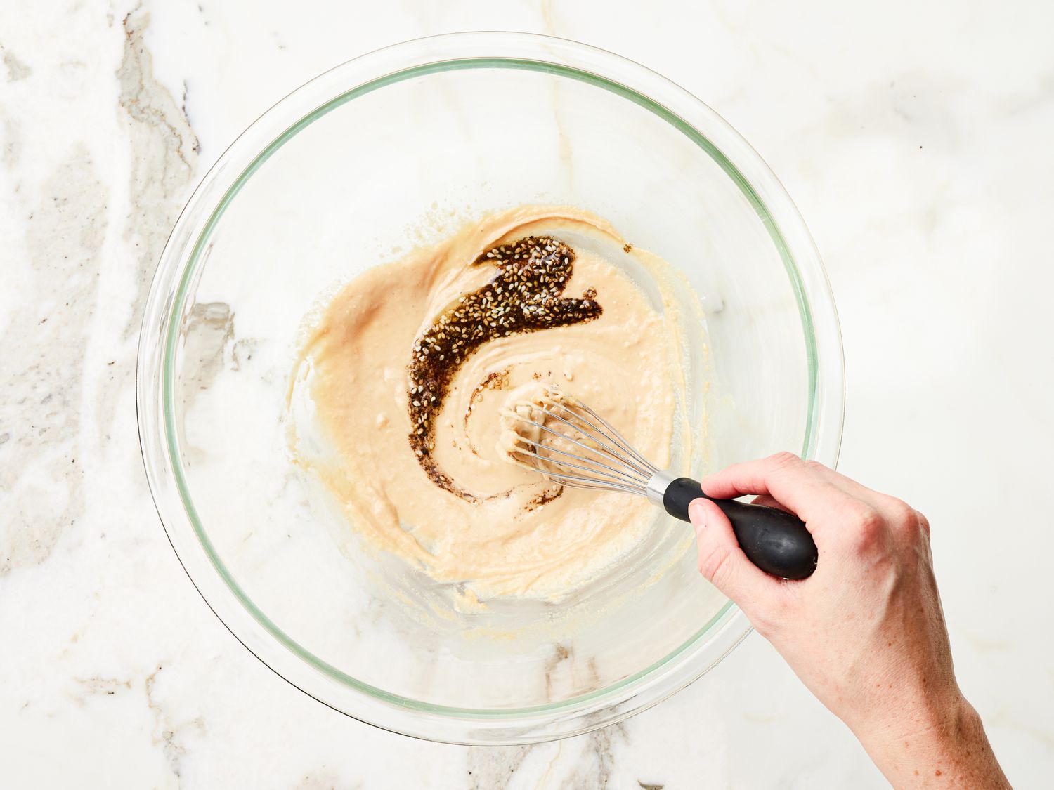 Mixing dressing together in a glass bowl