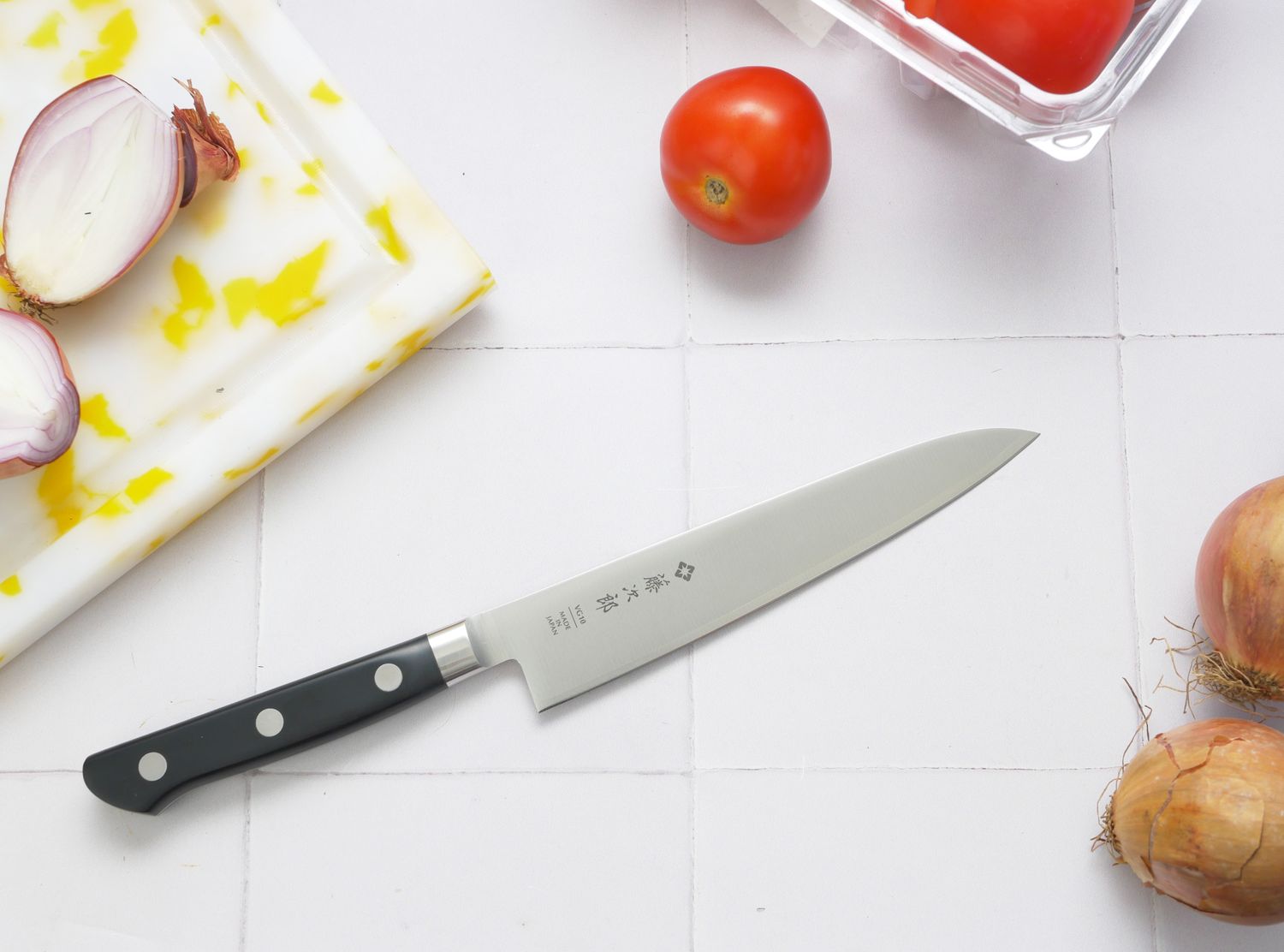a knife on a white tile surface