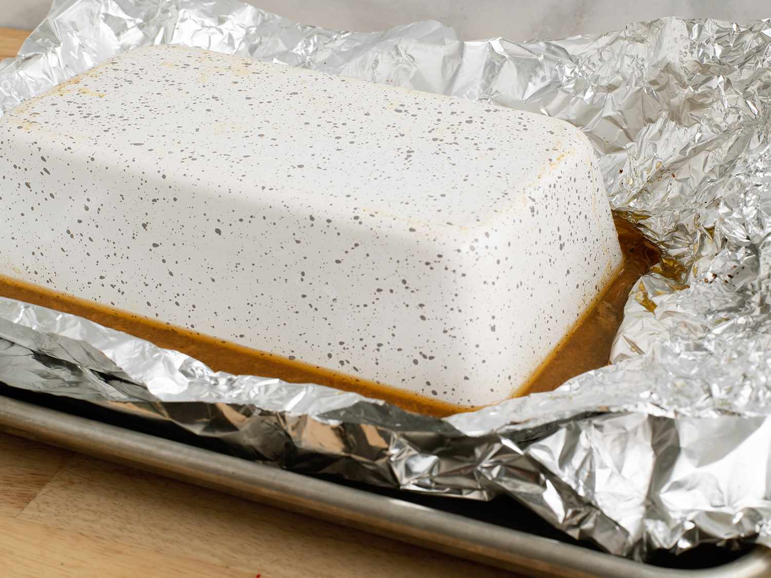 Inverted baking dish on aluminum foil 