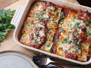 Overhead of spinach and ricotta manicotti baked in tomato sauce.