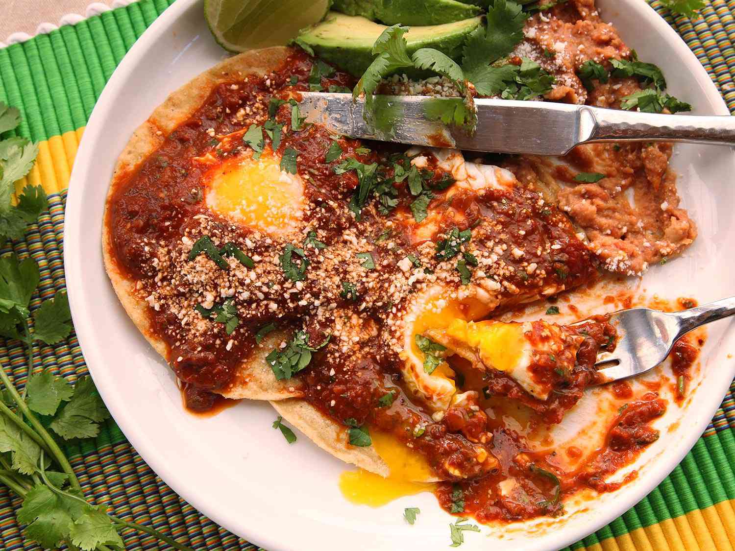 A plate of homemade huevos rancheros with tomato chile salsa.