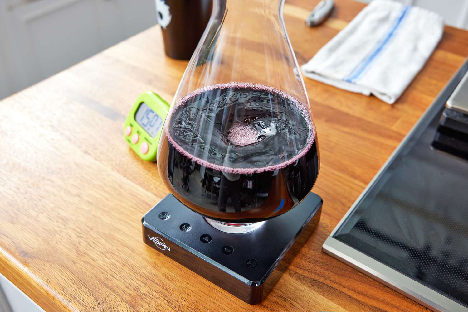 An electric wine decanter spinning red wine around in its carafe