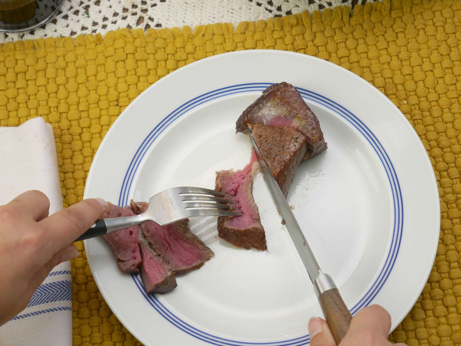 the serrated greenpan steak knife tearing a piece of steak off