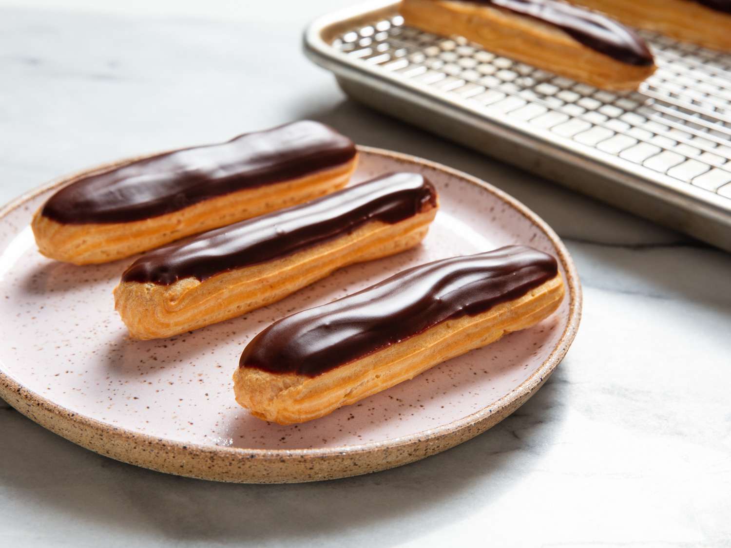 A plate of chocolate éclairs.