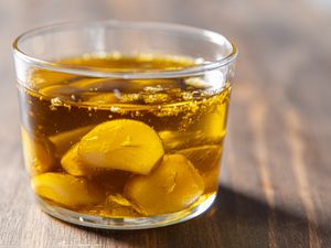Garlic cloves in oil in a glass container
