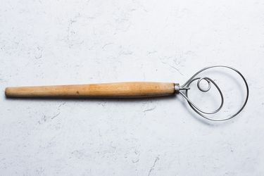 a Danish dough whisk on a white background