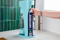 A person adding the CO2 canister to the DrinkMate.