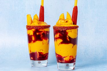 Two Mangonadas on a textured blue background