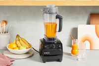Vitamix 5200 Professional-Grade Blender filled with orange smoothie