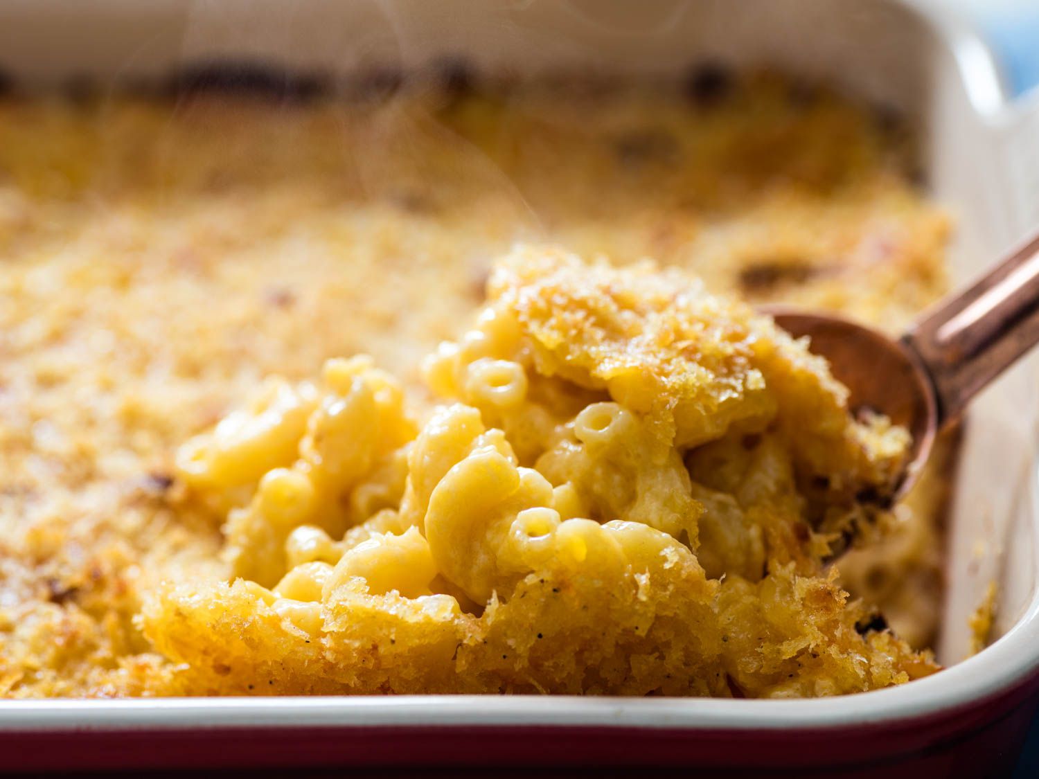 Scooping up a just baked portion of classic macaroni and cheese.
