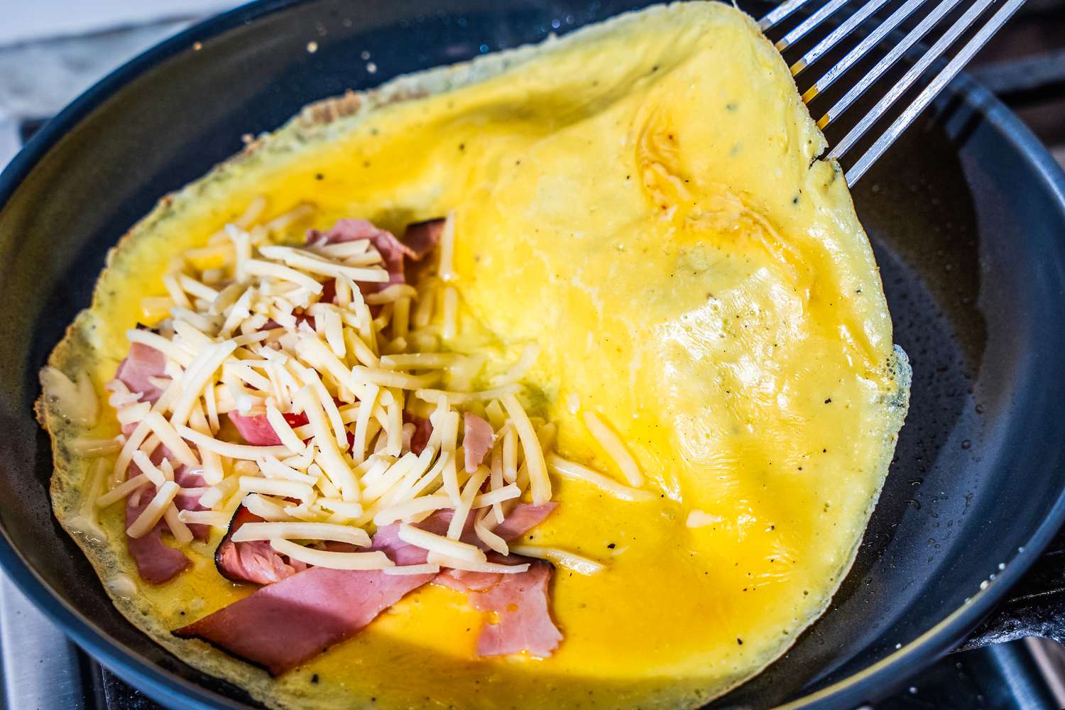 An omelette being cooked in the OXO Non-Stick Pro 10-Inch Frypan