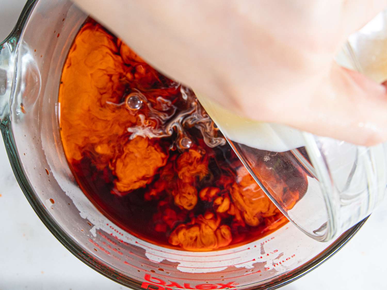 Overhead view of adding condensed milk