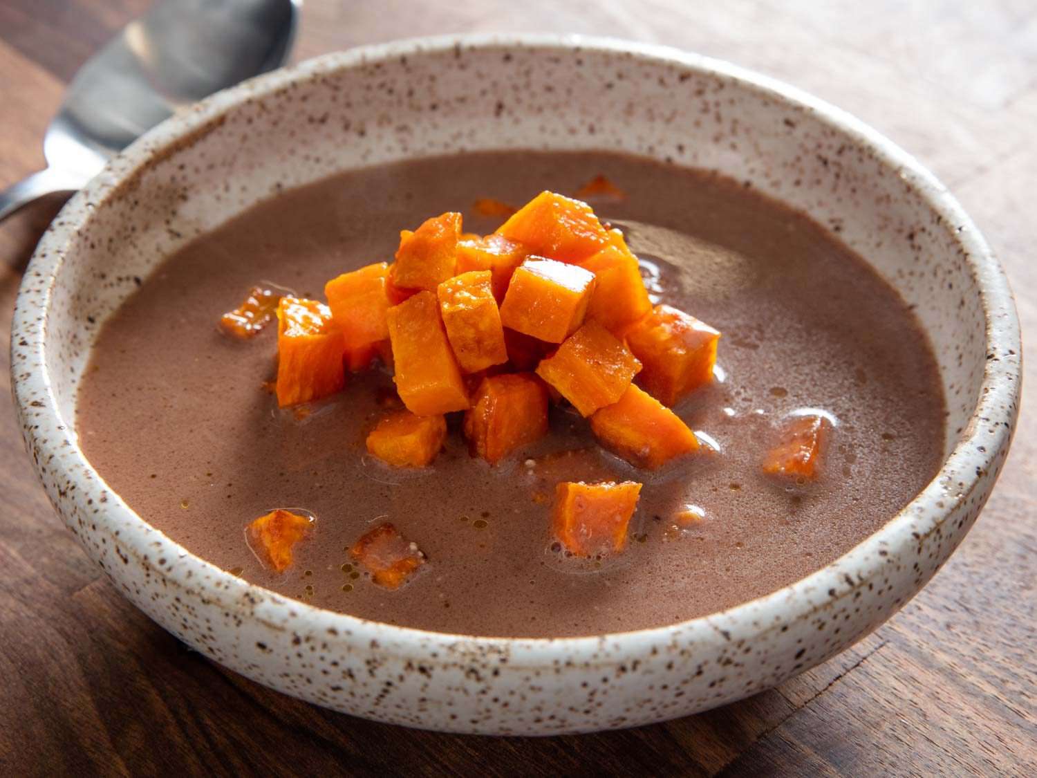 A bowl of kanuchi (Cherokee nut soup) with a sweet potato garnish.