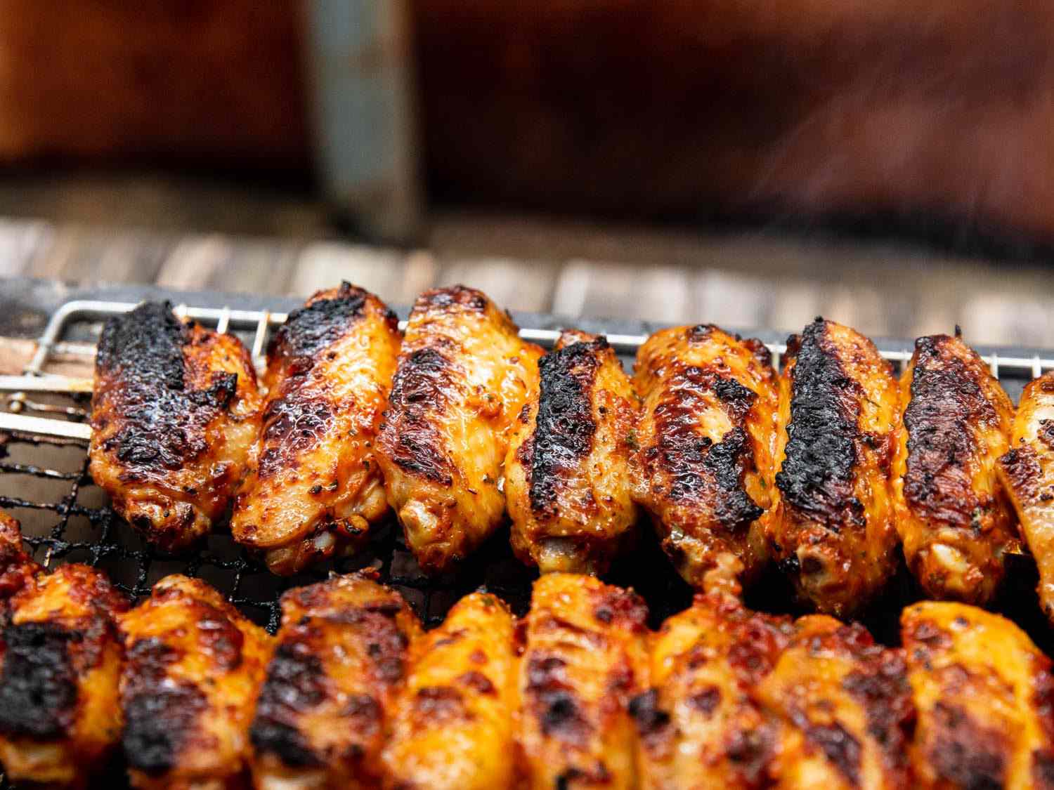 Closeup of Turkish-style wings grilling on a Japanese konro grill.