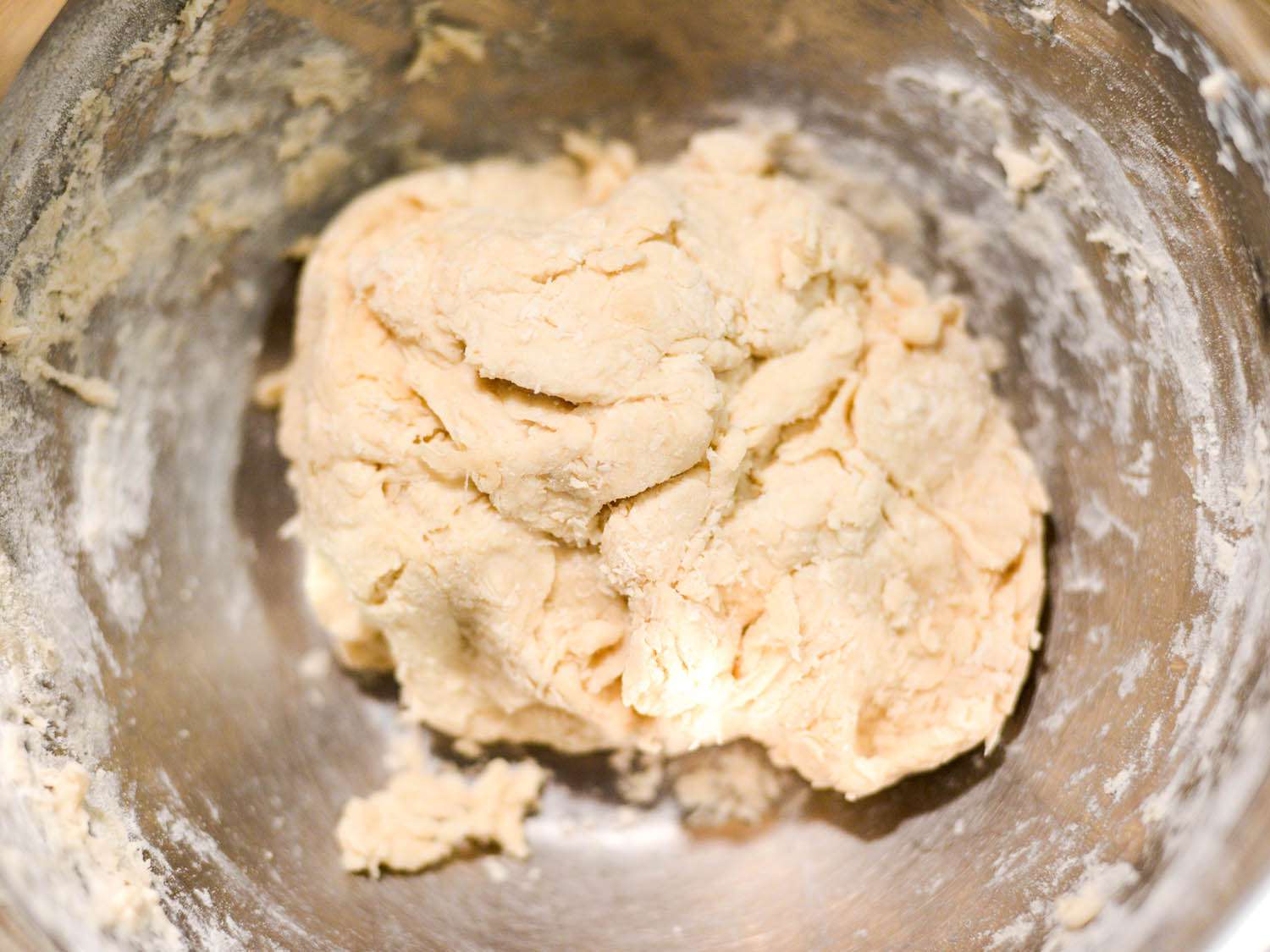 Flour, salt and lard formed into a dough in a mixing bowl. 