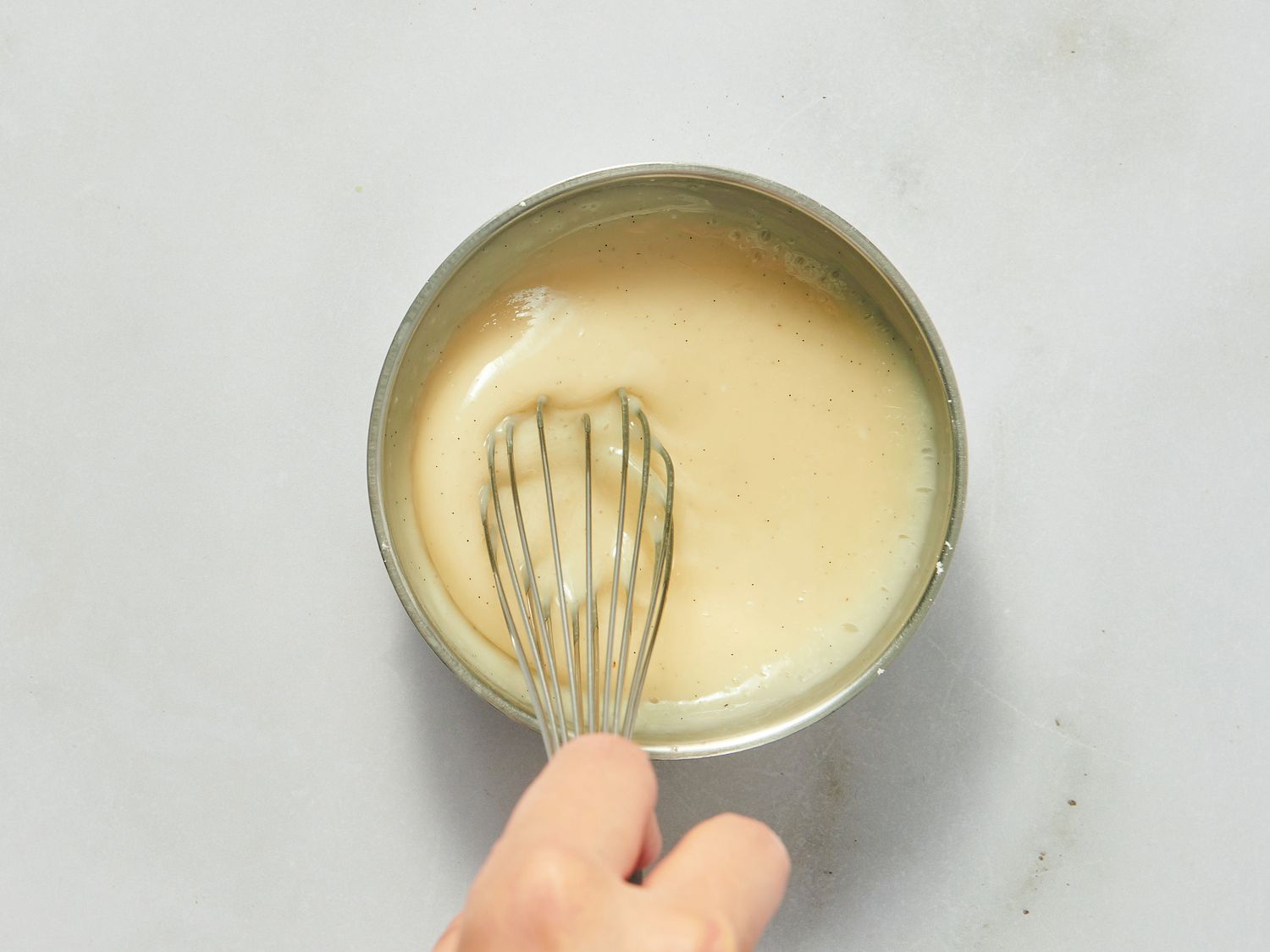 Whisking a glaze together in a bowl. 