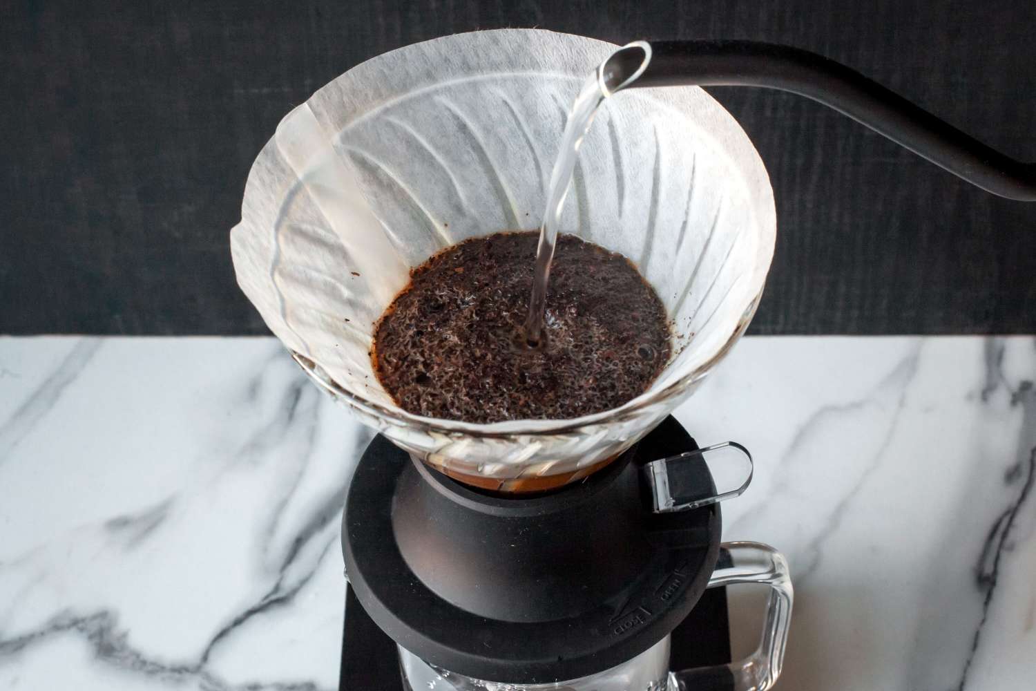 Water being poured over coffee grounds in the Hario Switch pour-over dripper