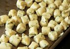 A baking sheet with Parisian Gnocchi resting on top 