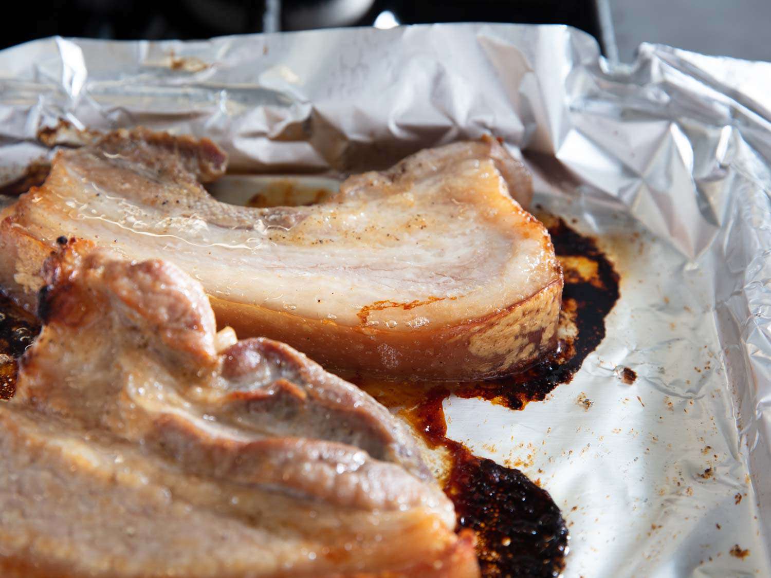 The marinated pork belly after roasting, ready to cool and slice.
