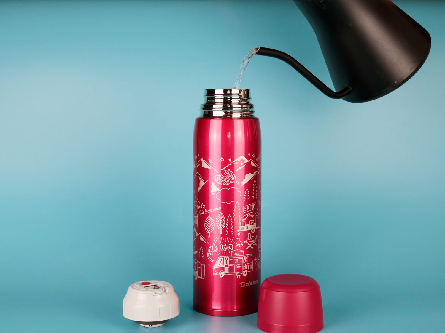 A gooseneck kettle pouring hot water into a thermos