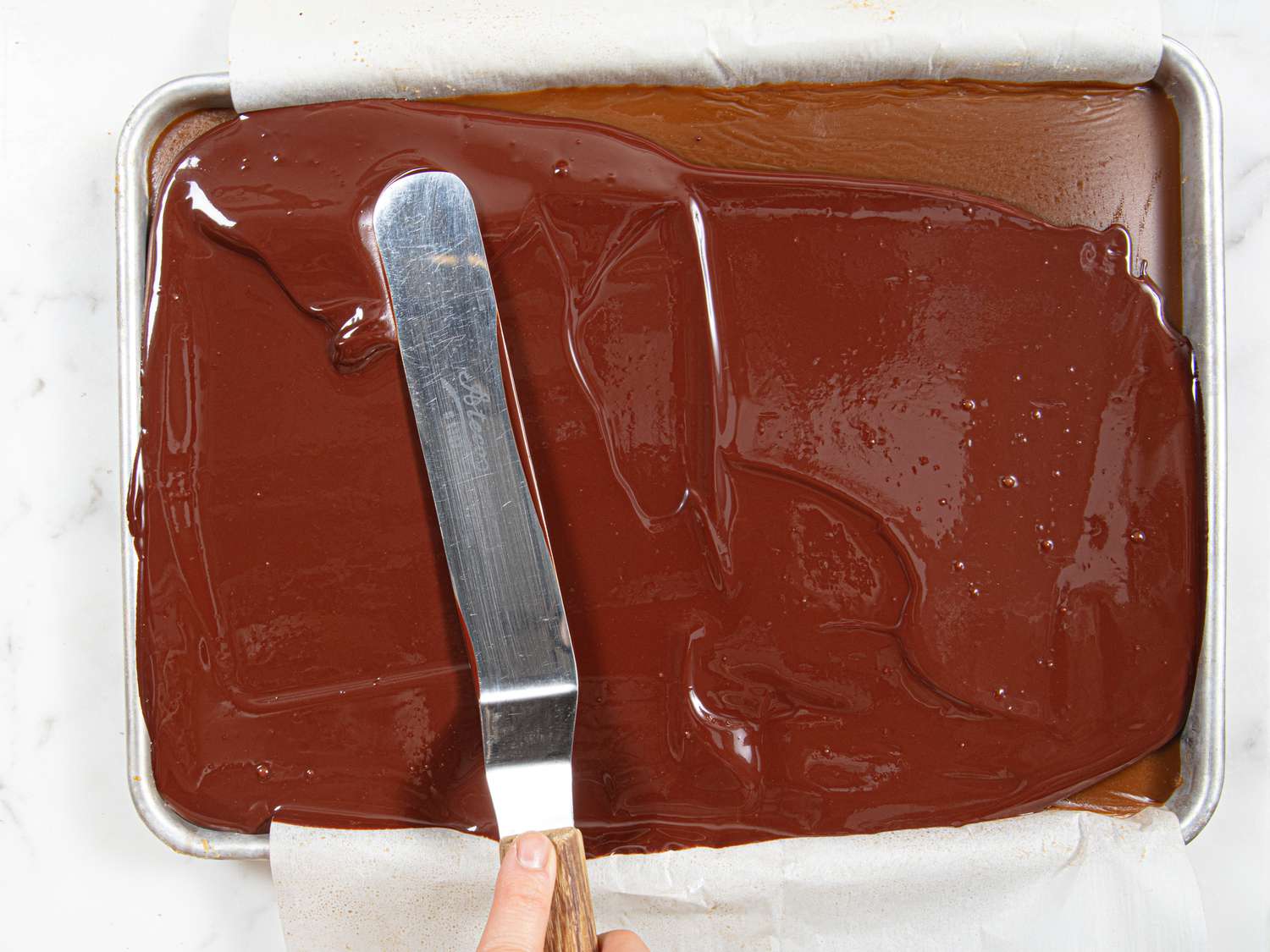 Overhead view of spreading chocolate topping