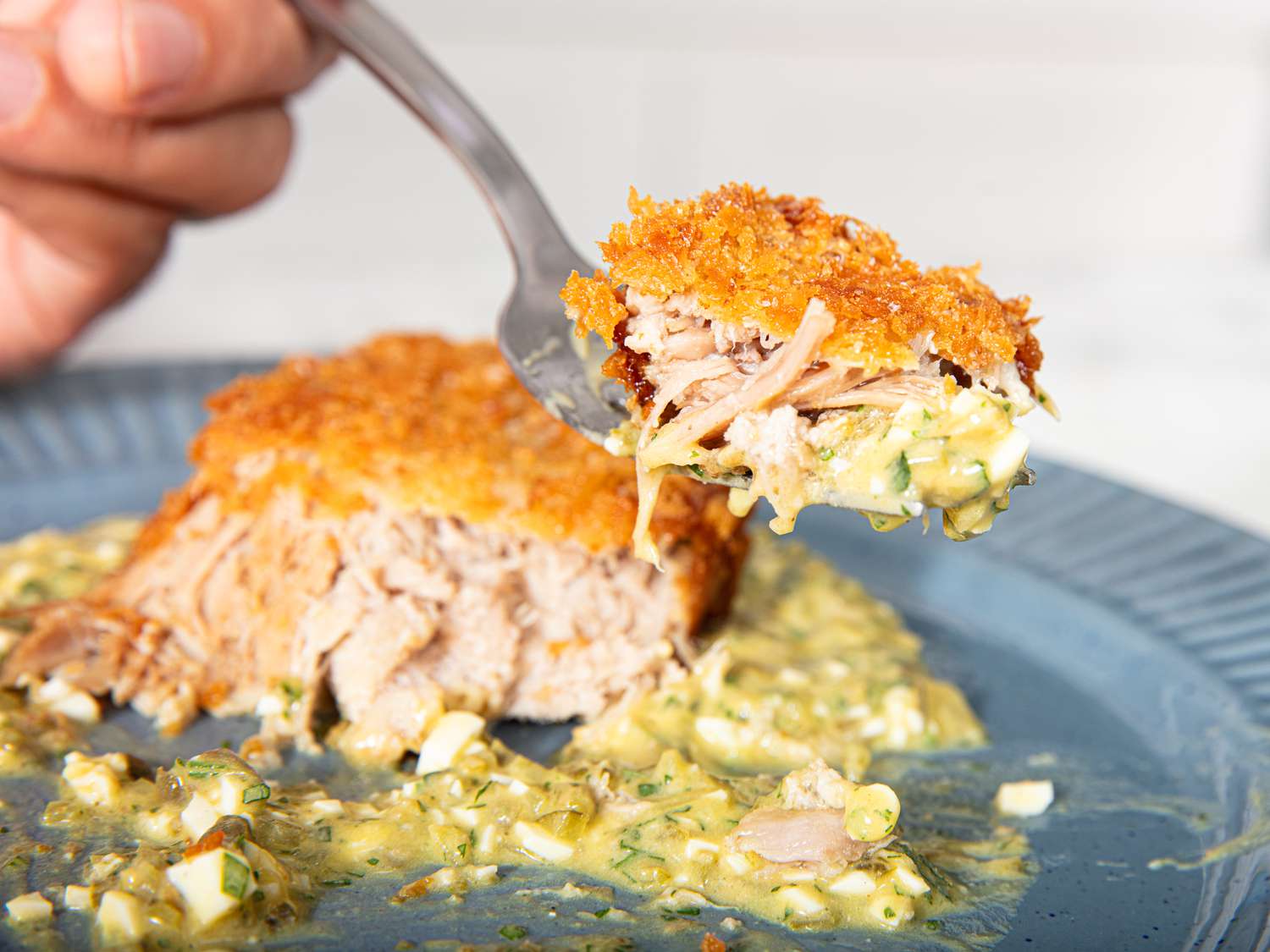 Side view of bite of pork croquettes