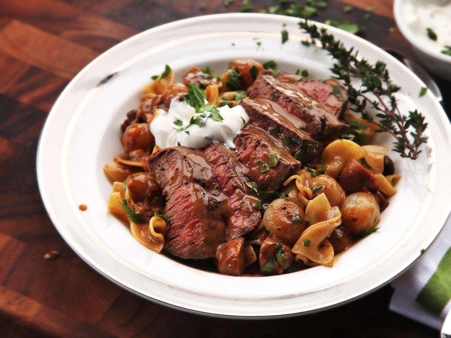 Beef stroganoff resting in a white bowl