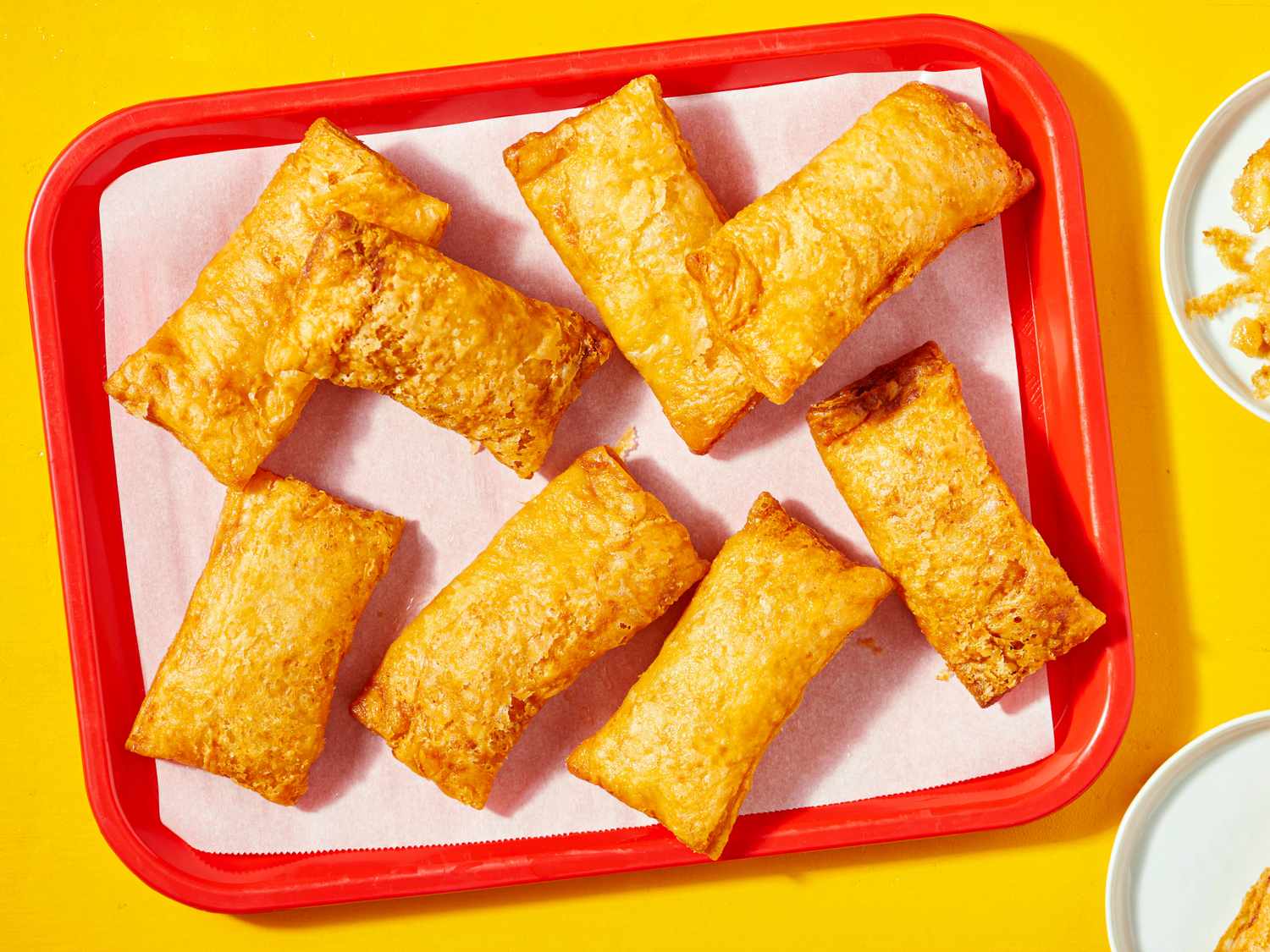 Tray of seven baked apple hand pies on parchment paper